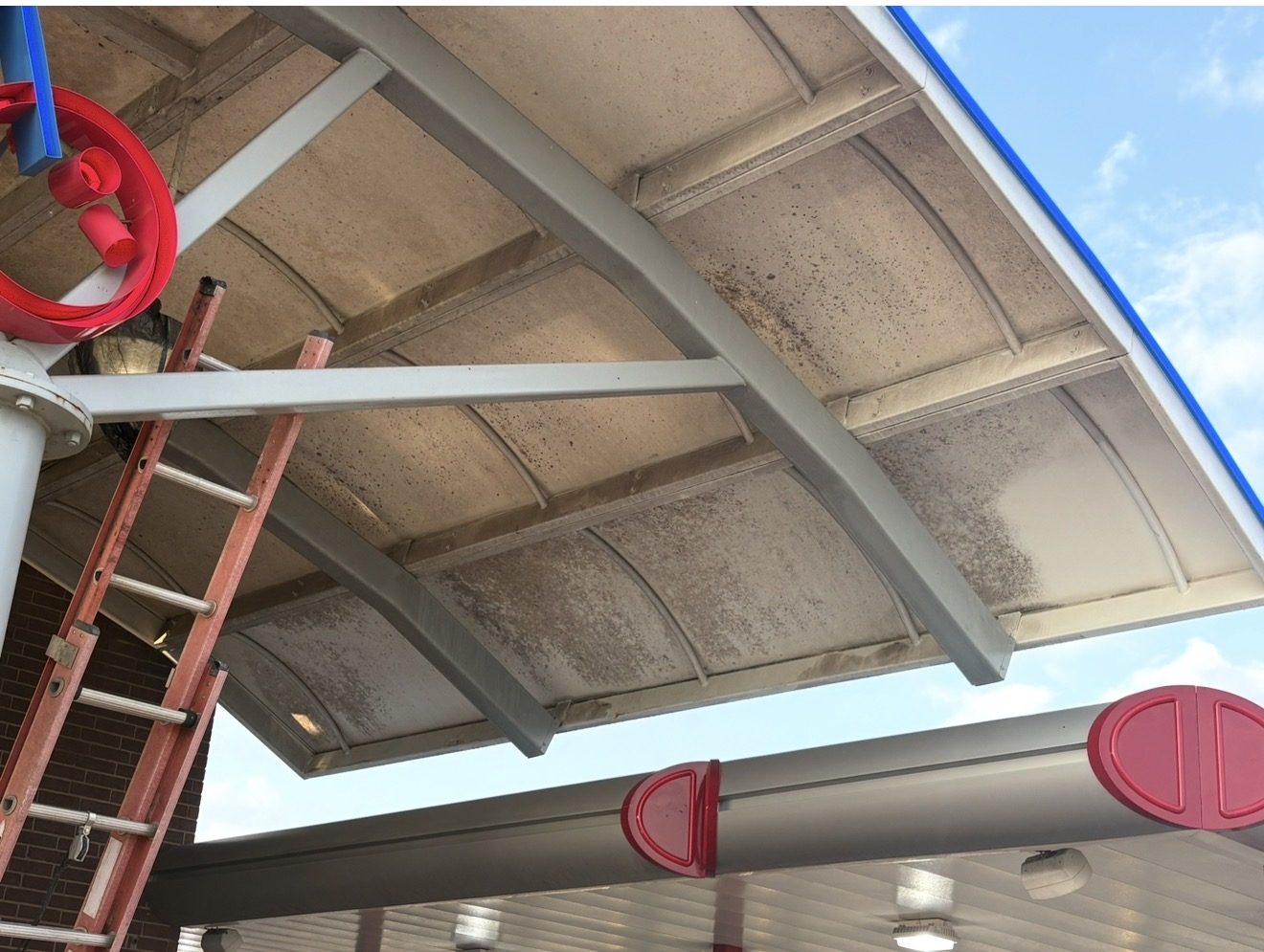 Commercial canopy structure before pressure washing