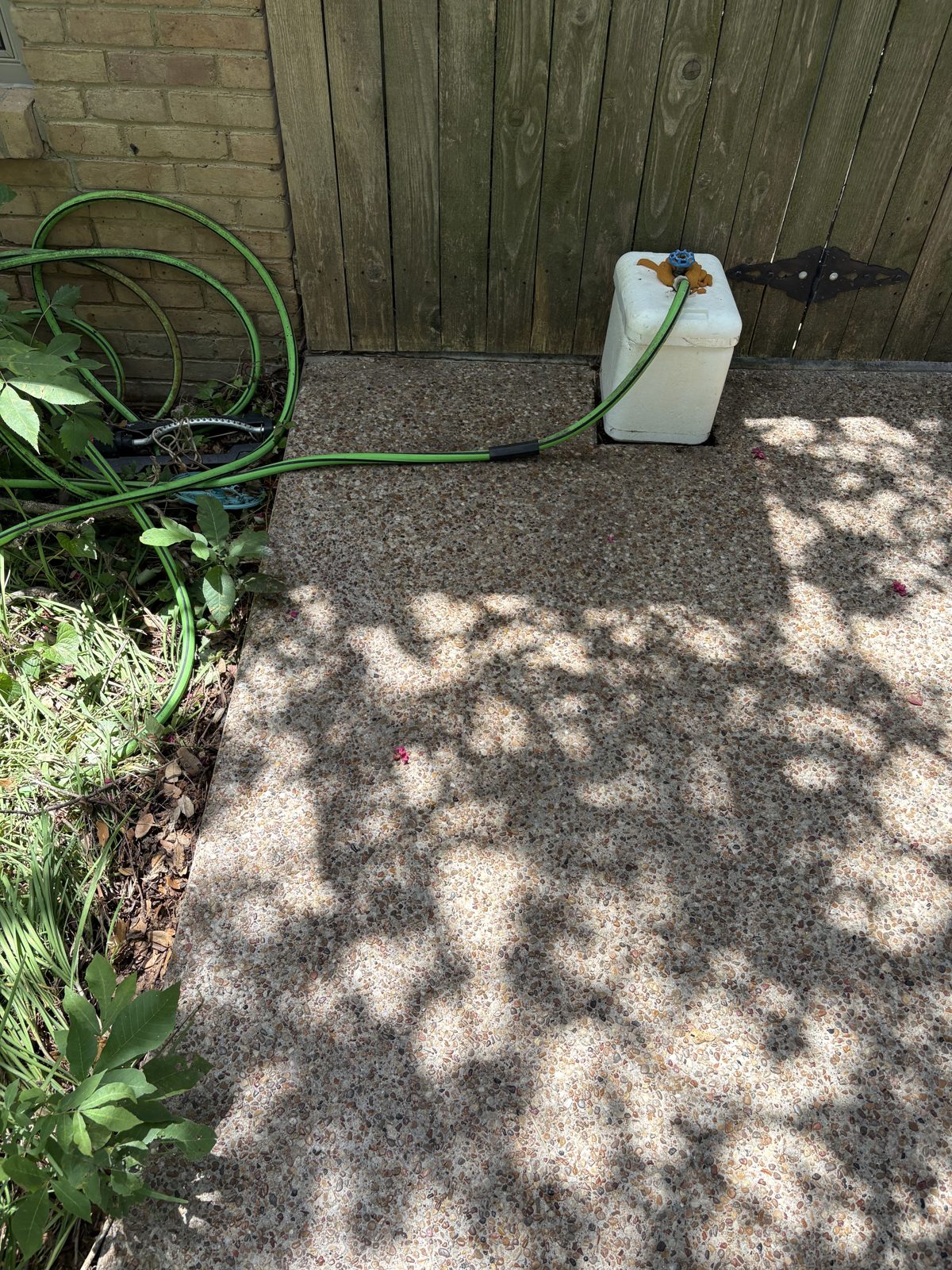 Clean aggregate concrete patio after pressure washing