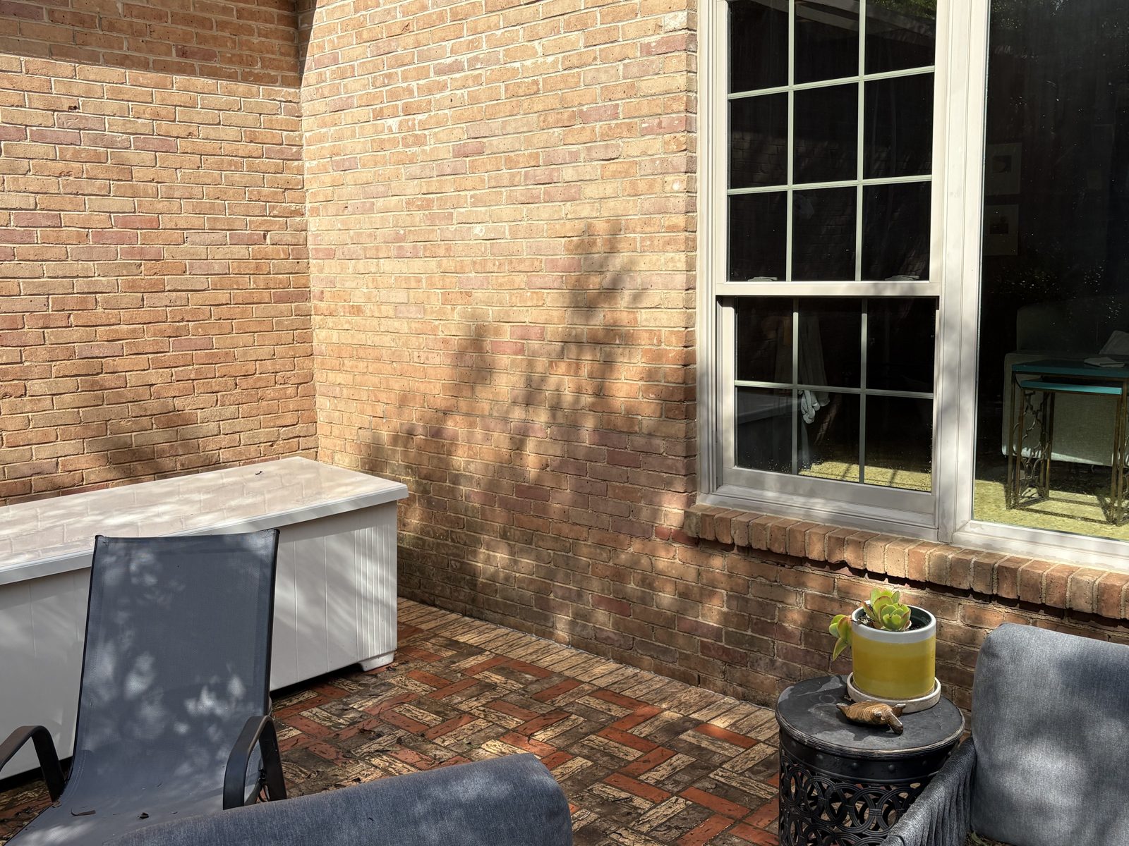 Brick patio seating area after pressure washing