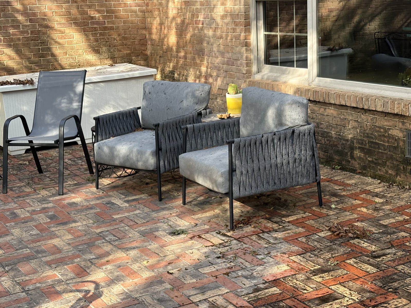 Brick patio seating area before pressure washing