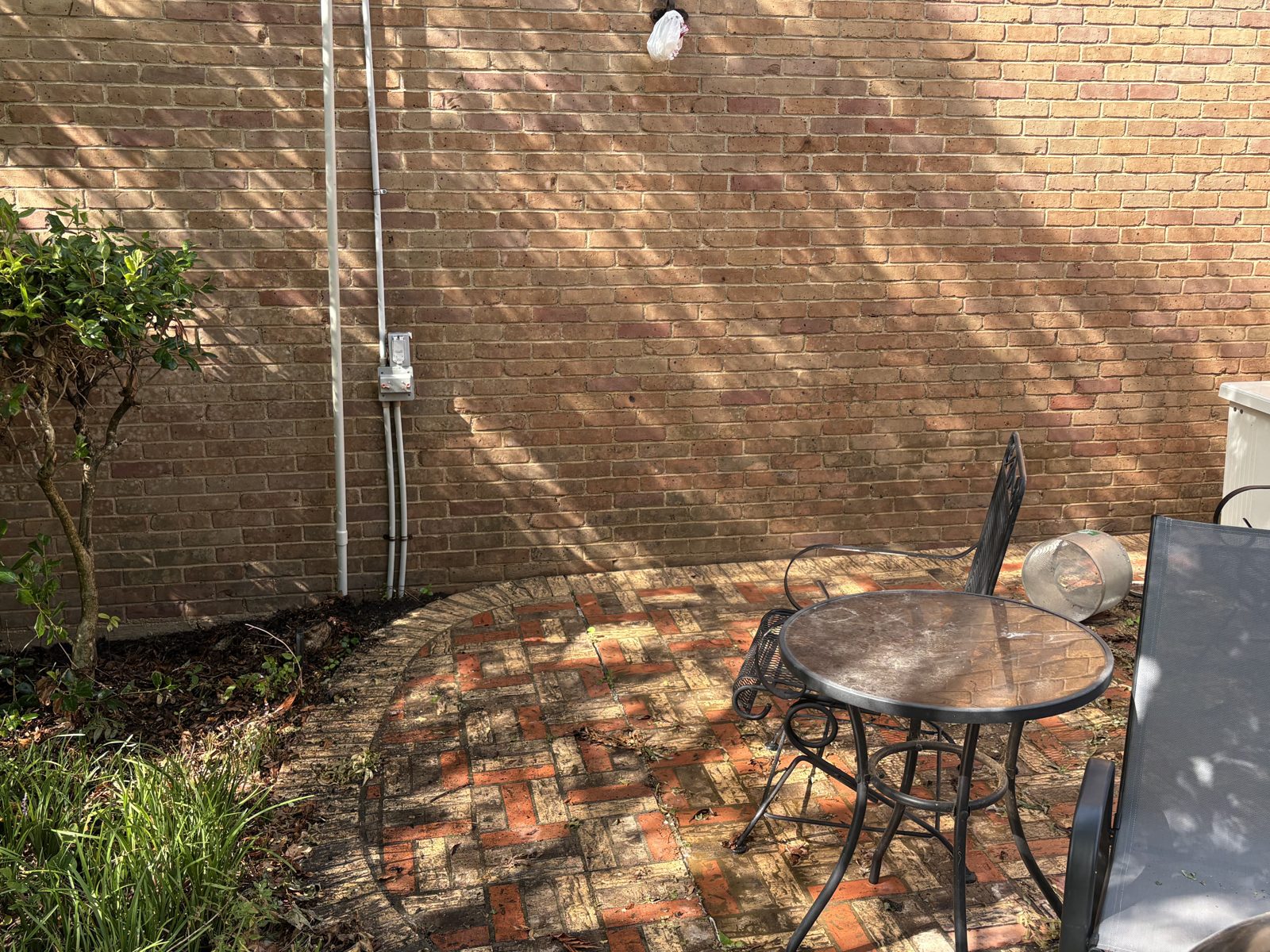Brick patio and wall after pressure washing