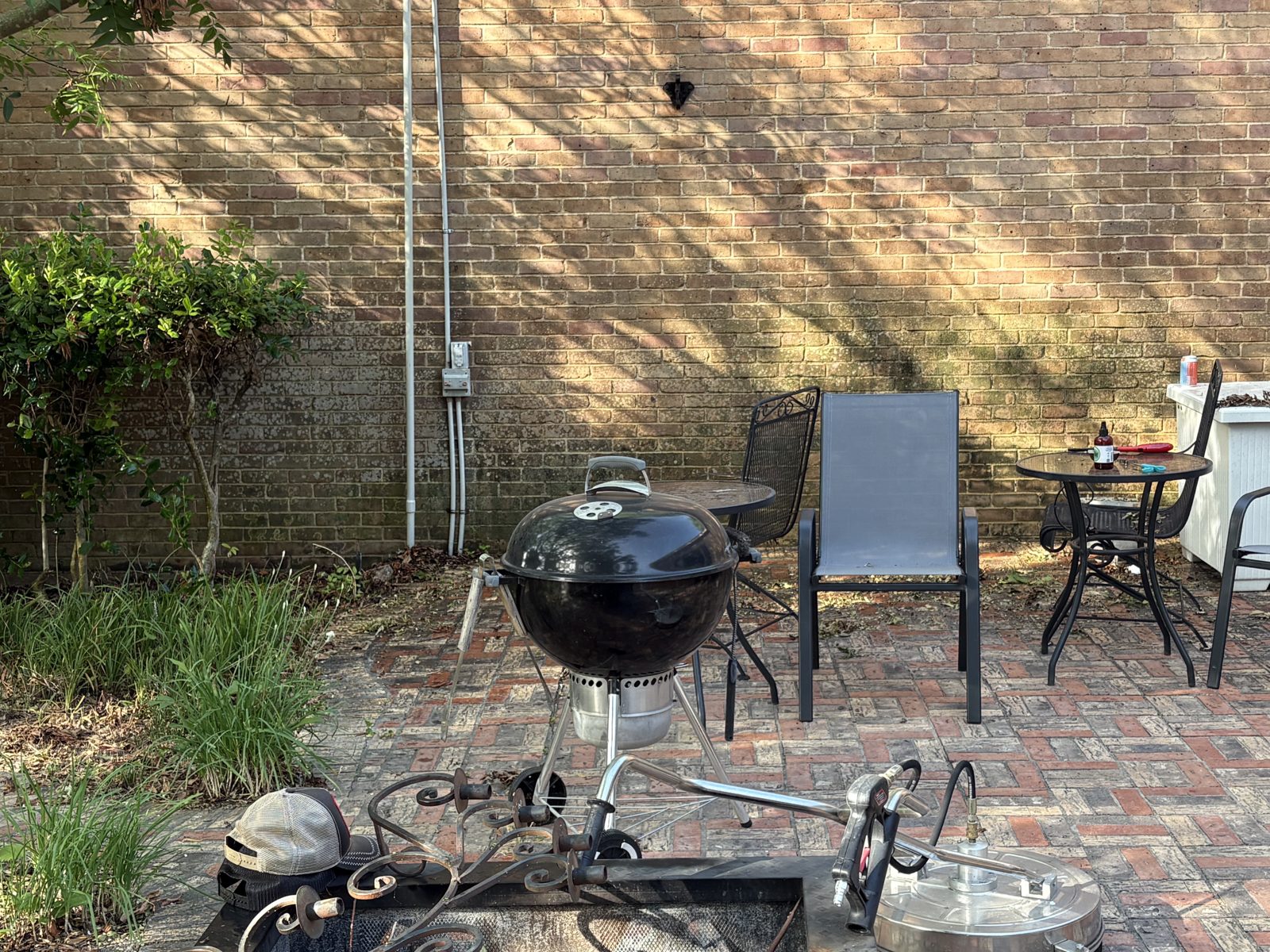 Brick patio and wall before pressure washing