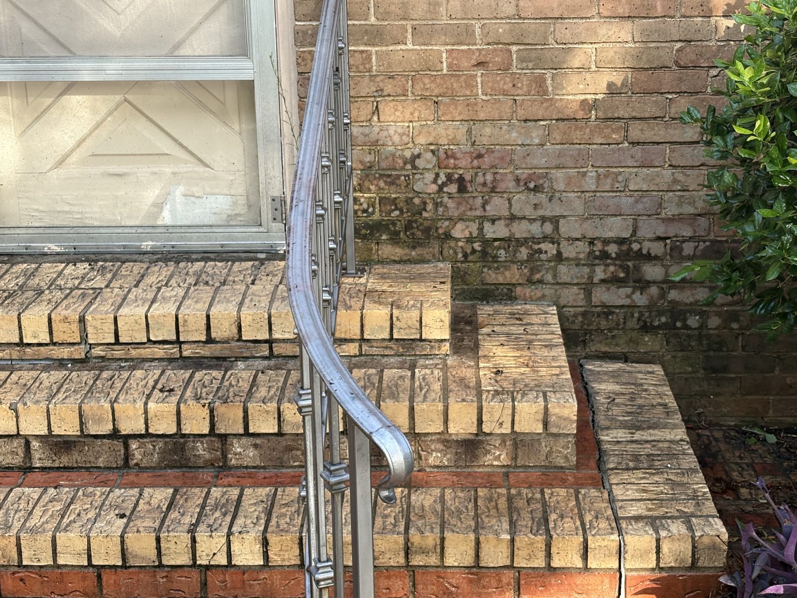 Brick entry steps with algae before cleaning