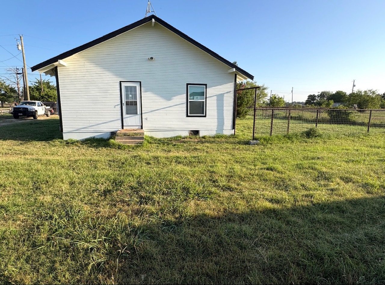 Ranch house yard before mowing, dry grass